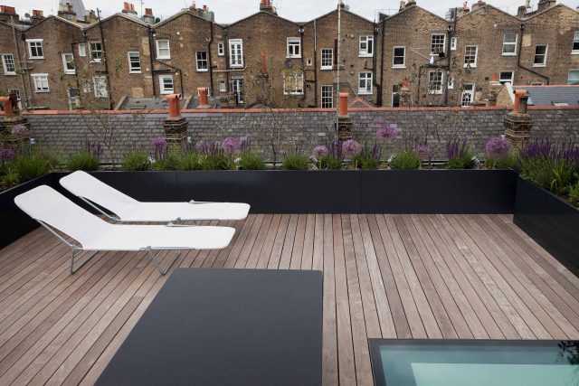 Finished residential roof terrace construction featuring modern decking and planters
