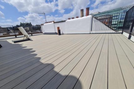 Eco-friendly composite decking made from recycled materials providing a durable foundation for a London rooftop oasis.