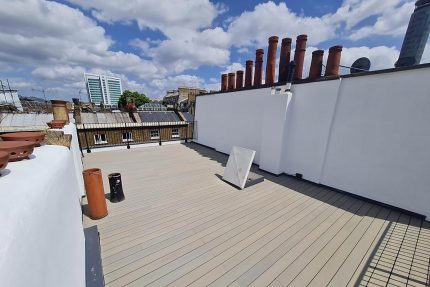 Bespoke metal and glass perimeter railings ensuring safety while maximizing panoramic views from the rooftop.
