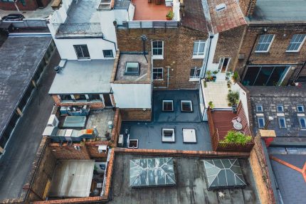 Flat roof conversion approved by building regulations, showing precise cutouts for multiple electric skylights.