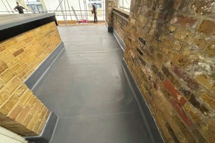 Sleek and modern felt roof replacement adding sophistication and improved insulation to a residential property.