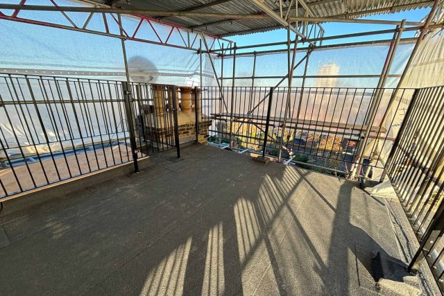 Extensive commercial-grade scaffolding and protective railings erected for a high-performance felt roof replacement.