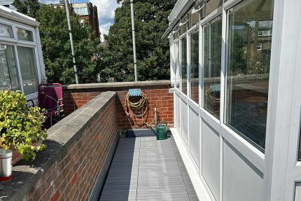 Precision-engineered garden balcony renovation featuring weather-proof composite decking and premium London roofing craftsmanship.
