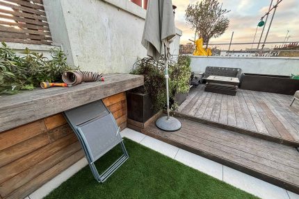 Split-level timber decking accommodating modern outdoor seating on a refurbished residential roof terrace in Pimlico.