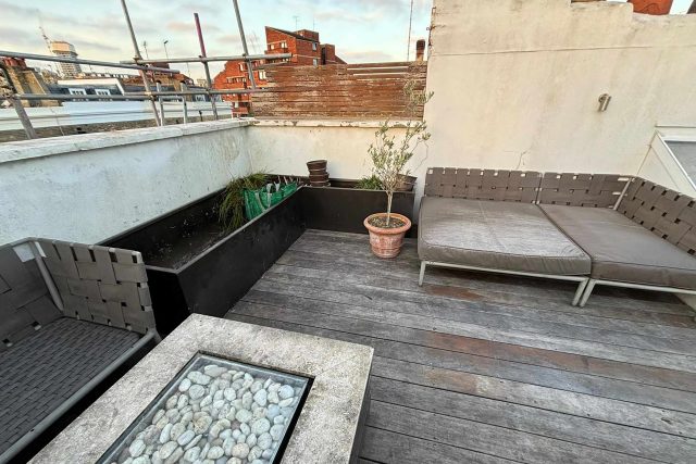 Initial stage of a balcony roof garden refurbishment in London showing the careful removal of existing decking.