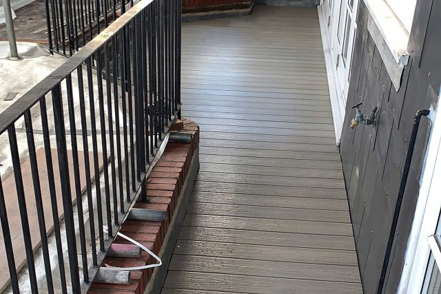 Newly installed flat roof and modern composite decking transforming an outdoor living space in Richmond.