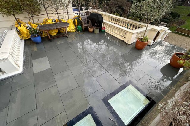 Sophisticated mix of classic and contemporary paving tiles providing a stylish backdrop for rooftop planters.