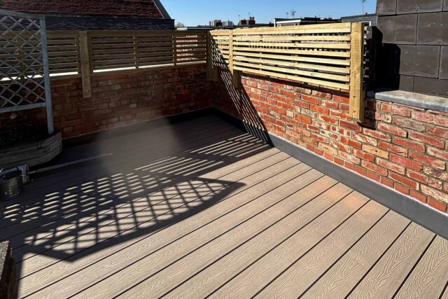 Zero-rot composite decking and tailored privacy screens fitted by our expert flat roofing London contractor team for a residential terrace.