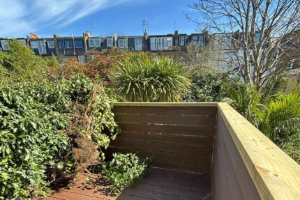 Robust structural privacy wall and premium decking completing a high-value domestic terrace refurbishment in Richmond, London.