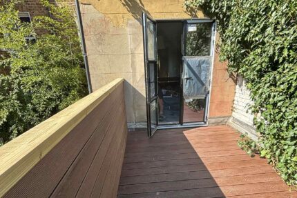 Slip-resistant composite decking and bespoke privacy screening forming a luxurious al-fresco living space by our expert flat roofer London team.