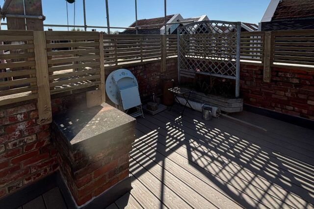 Premium composite decking and bespoke slatted privacy fencing installed during a high-end Central London flat roof conversion.