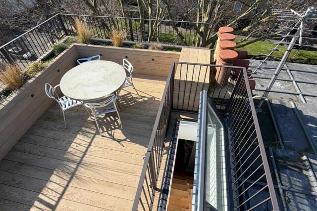 Secure automated roof hatch and structural planters showcased in a B2B flat roof conversion by our dedicated West Hampstead installation team.
