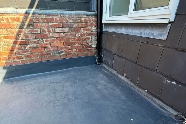 Precision EPDM rubber flat roof membrane showcasing expert waterproofing upstands executed by our London roofing builders.