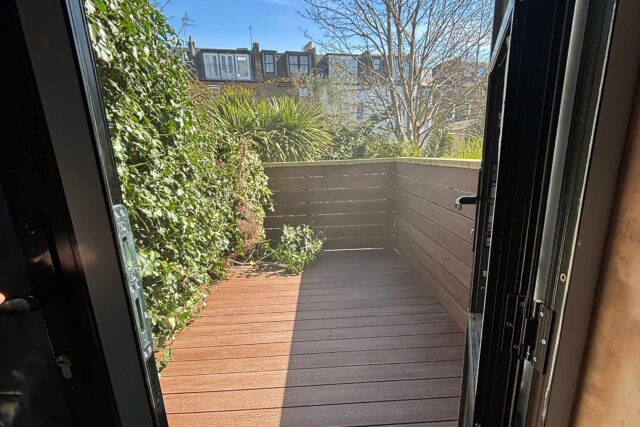 Flat Roof Terrace renovation company refurbished decking, felt roof replacement roofer near me latest in Richmond Surrey, sleek functional.