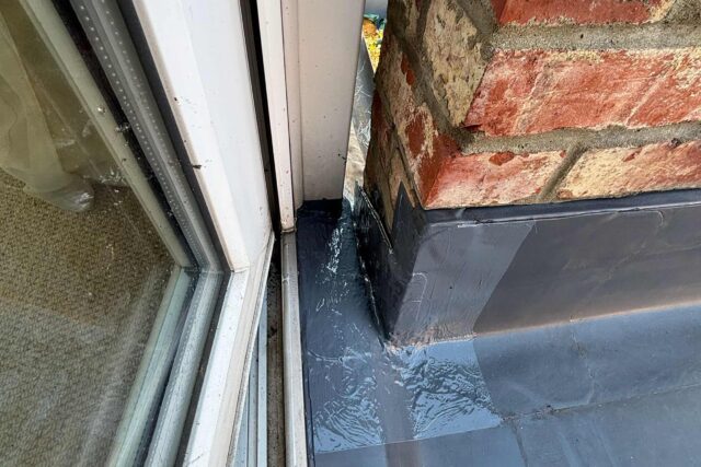 Advanced liquid waterproofing sealant perfectly detailed at the window and brick junction to ensure complete structural safety.