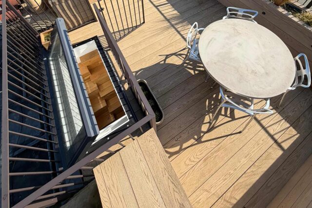 Fully accredited flat roofer London portfolio installation demonstrating precision alignment of commercial decking and advanced security hatch systems.