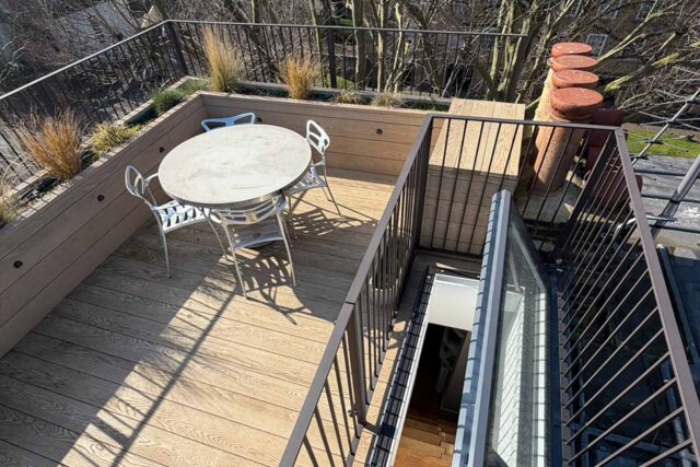 Integrated structural roof hatch access blending seamlessly into a zero-rot composite deck for a premium B2B roof garden upgrade.
