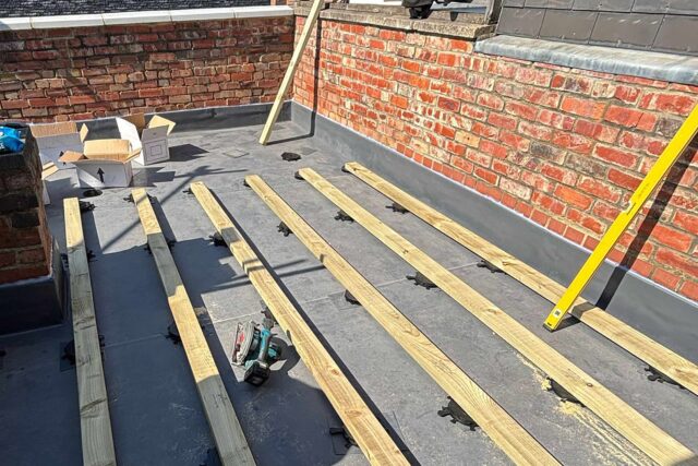 Structural timber deck joists and adjustable pedestals engineered by our specialist flat roofer London operatives.