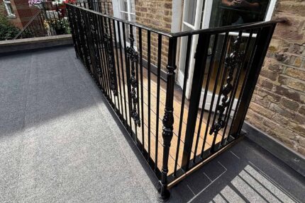 Ornate architectural ironwork fixed securely to a newly waterproofed deck showcasing our bespoke London roofing capabilities.