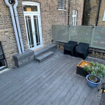 Structurally reinforced Millboard composite decking steps installed on a luxury London roof terrace to seamlessly bridge height variations.