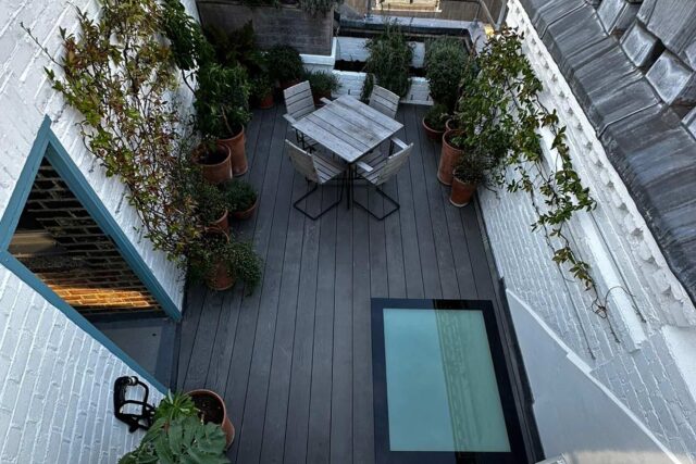 Structural glass skylight safely integrated into Millboard decking on a highly engineered flat roof conversion by our roofer London team.