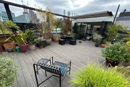 High-end residential roof terrace showcasing wood-free Millboard composite decking and modern outdoor furniture constructed by our London roofing specialists.