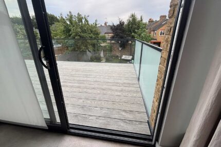 Installing bespoke timber furring pieces and Rockwool insulation for a cold roof assembly.