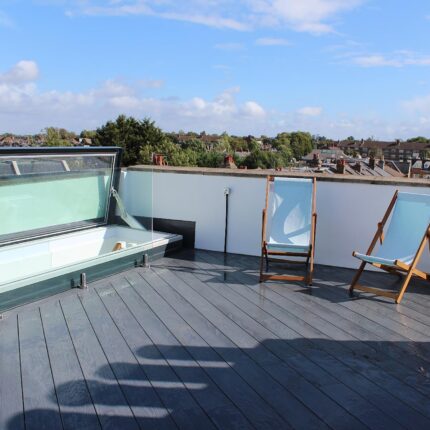 Finished residential roof terrace construction featuring modern decking and planters