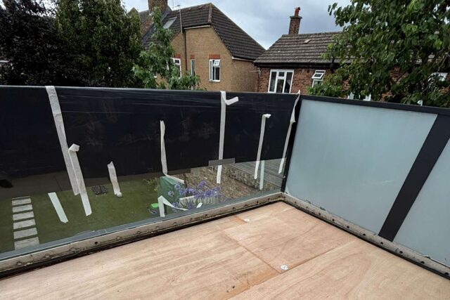 Waterproof IKO Armourplan single-ply membrane installed on a Queen's Park flat roof.