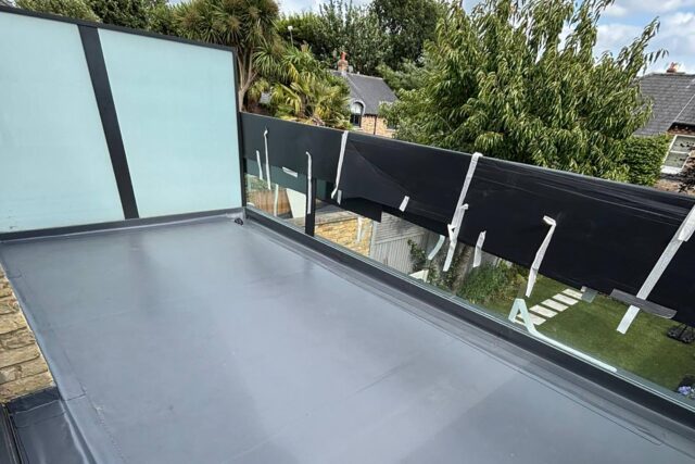 Close-up of premium composite decking and seamless drainage on a converted flat roof.