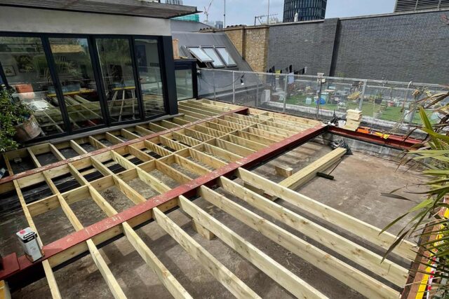 Anti-corrosive treated timber deck frame joists installed during a structural flat roofing London project by our expert contractors.