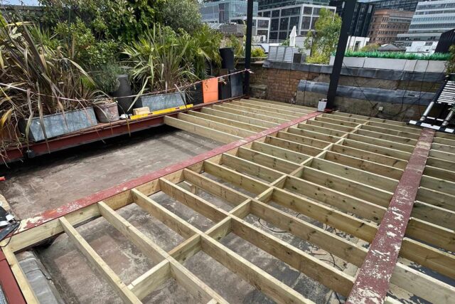 Complex timber joist deck framework engineered for long-lasting structural integrity on a residential Shoreditch roof terrace.