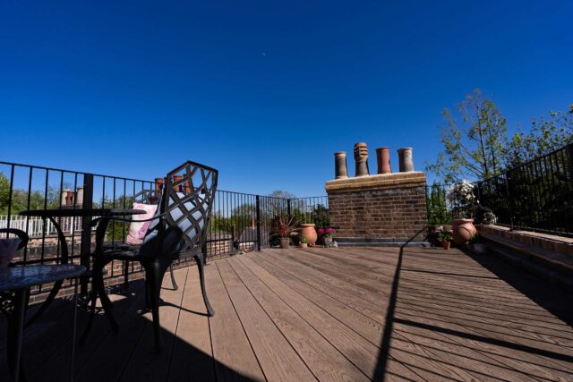 Explore our bespoke flat roof terrace transformation in Belsize Park. Luxury composite decking, glass balustrades, and urban landscaping.