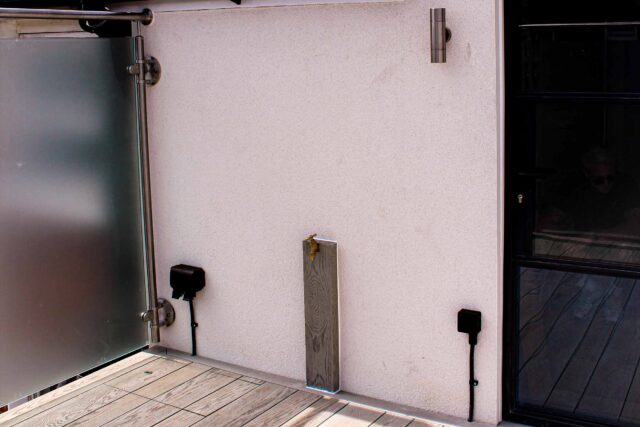 Bespoke brass outdoor taps mounted on structural timber posts to provide premium lifestyle upgrades for this flat roofing London project.