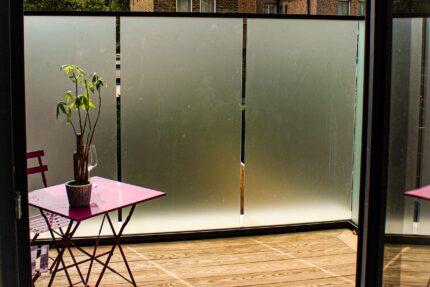 Bespoke frosted privacy glass and sleek black aluminium handrails installed for a high-end residential project by our expert roofer London team.